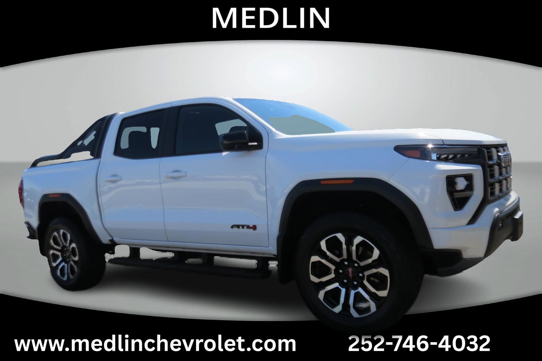 2025 GMC Canyon AT4 in Summit White — front three-quarter view