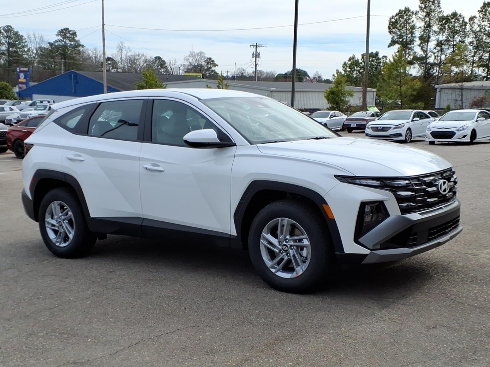 2026 Hyundai TUCSON SE in Serenity White Pearl — front three-quarter view